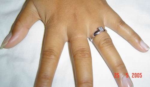 the engagement ring has a square diamond which tapers in where it meets the thick band