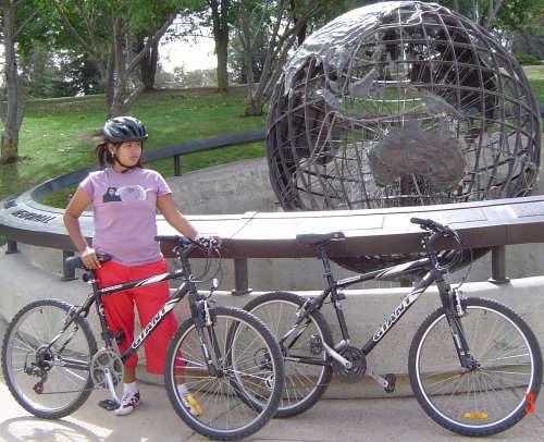 Dany bike-riding past Captain Cook's memorial